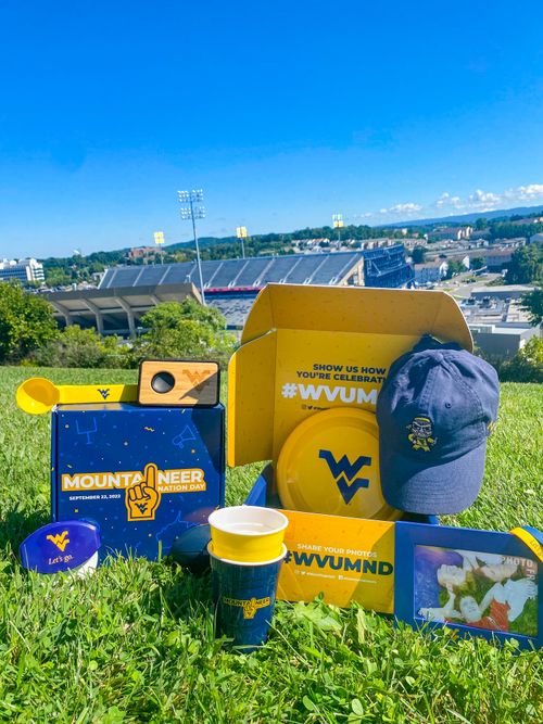 Mountaineer Nation Day box with WVU product and stadium in background